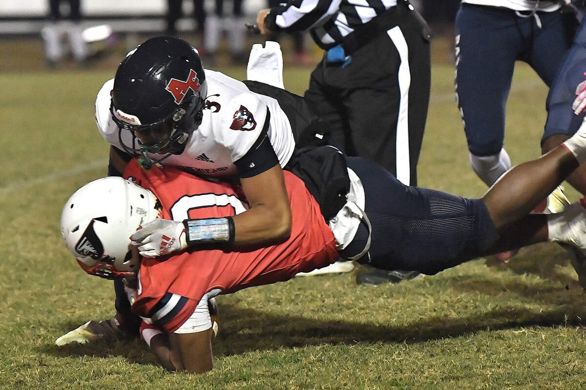 Apex Friendship’s Jaxon Alongi (3) tackles Jordan’s Omarion Blue (0) during the first half. The Apex Friendship Patriots and the Durham Jordan Falcons met in the second round of the NCHSAA 4A playoffs in Durham, N.C. on November 22, 2024.