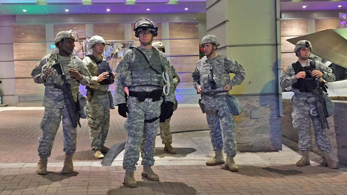 National Guard soldiers monitor a peaceful march through uptown Charlotte, N.C., on Sept. 23, 2016. North Carolina school board members were asked if they'd support placing the National Guard at some schools to try to boost security.