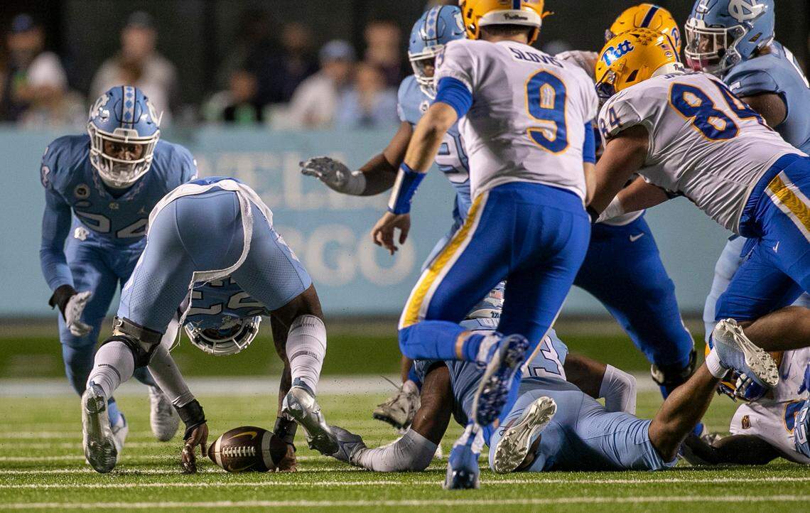 North Carolina’s Power Echols (23) works to recover a fumble by Pitt’s Israel Abanikanda (2) in the fourth quarter. Teammate Cedric Grey (33) forced the fumble and recovered the ball on Saturday, October 29, 2022 at Kenan Stadium in Chapel Hill, N.C.
