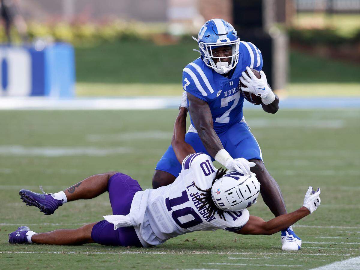 Duke’s Jordan Waters runs the ball under pressure from Northwestern’s Theran Johnson during the second half of the Blue Devils’ 38-14 win on Saturday, Sept. 16, 2023, at Wallace Wade Stadium in Durham, N.C.