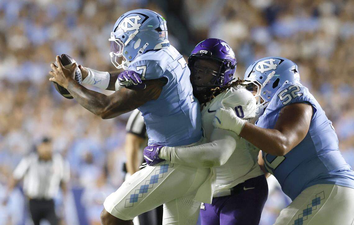TCU’s Zach Chapman (0) wraps up North Carolina quarterback Gio Lopez (7) during the first half of UNC’s game against TCU at Kenan Stadium in Chapel Hill, N.C., Monday, Sept. 1, 2025.