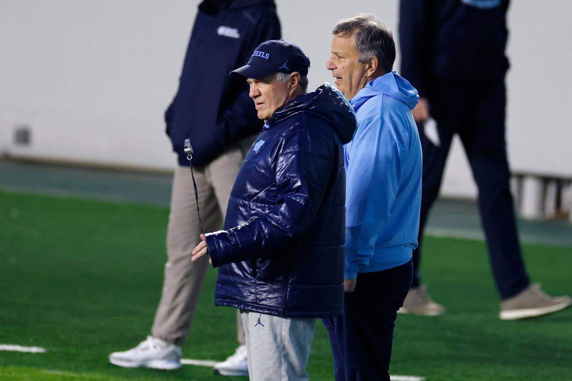 North Carolina football general manager Michael Lombardi talks with head football coach Bill Belichick during UNC football’s Practice Like a Pro open practice at Kenan Stadium in Chapel Hill, N.C., Saturday, April 12, 2025.
