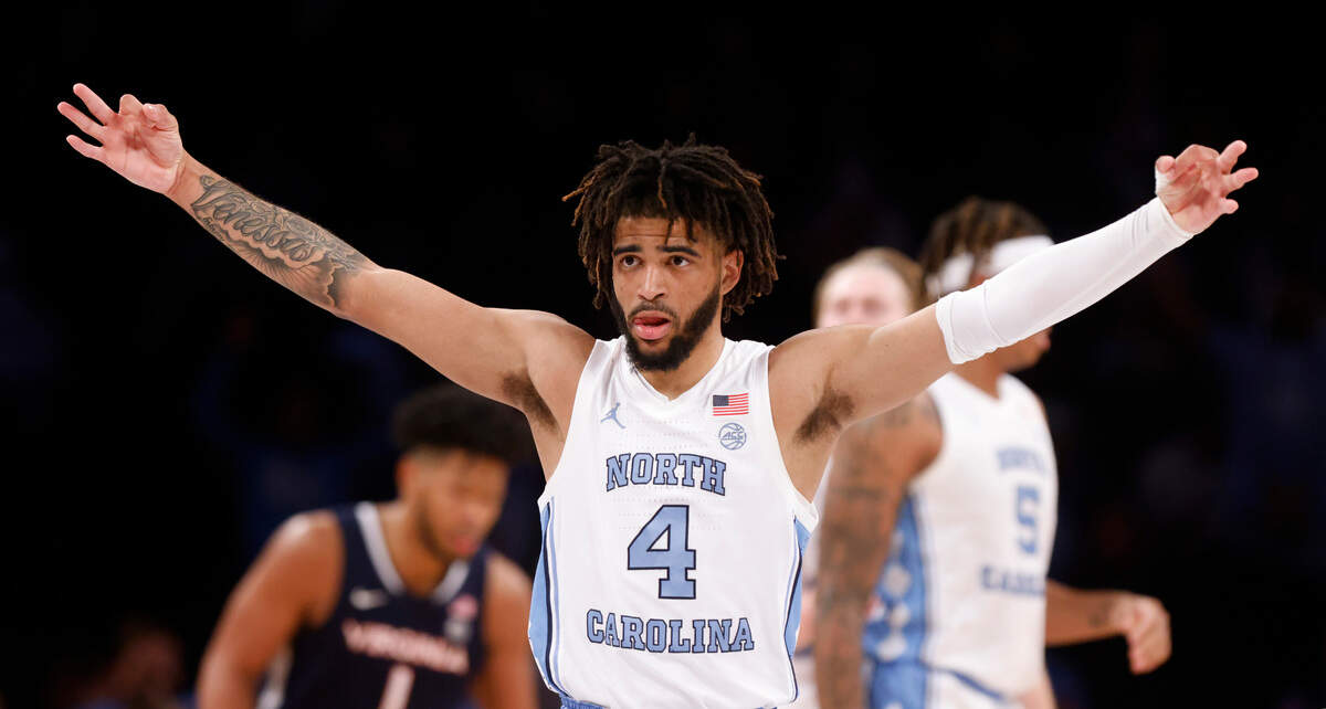 North Carolina’s R.J. Davis (4) celebrates after Caleb Love made a three-pointer during the second half of UNC’s 63-43 victory over Virginia in the quarterfinals of the ACC men’s basketball tournament at the Barclays Center in Brooklyn, N.Y., Thursday, March 10, 2022.