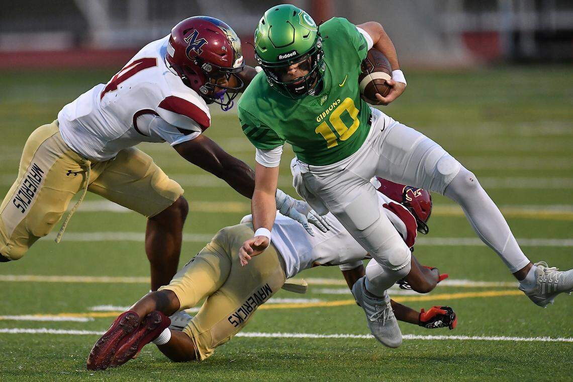 Cardinal Gibbons quarterback Conner Lindsey (10) avoids the tackle from  the Mallard Creek defense to earn the first down during the first half. The Mallard Creek Mavericks and the Cardinal Gibbons Crusaders met in a non-conference football game in Raleigh, N.C. September 19, 2025