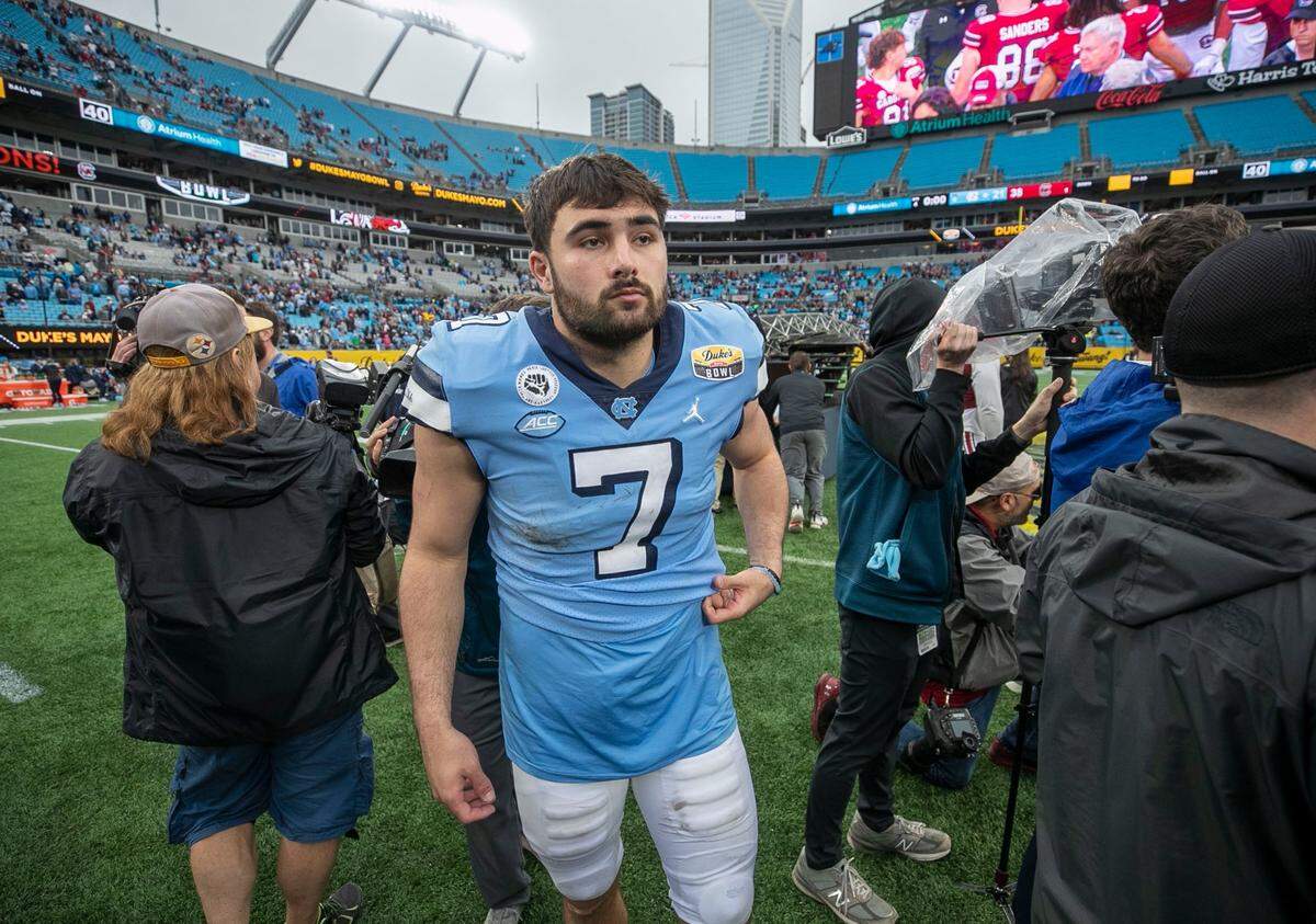 North Carolina quarterback Sam Howell looks to congratulate South Carolina coach Shane Beamer following the Gamecocks’ 38-21 victory over North Carolina on Thursday, December 30, 2021 at Bank of America Stadium in Charlotte, N.C.
