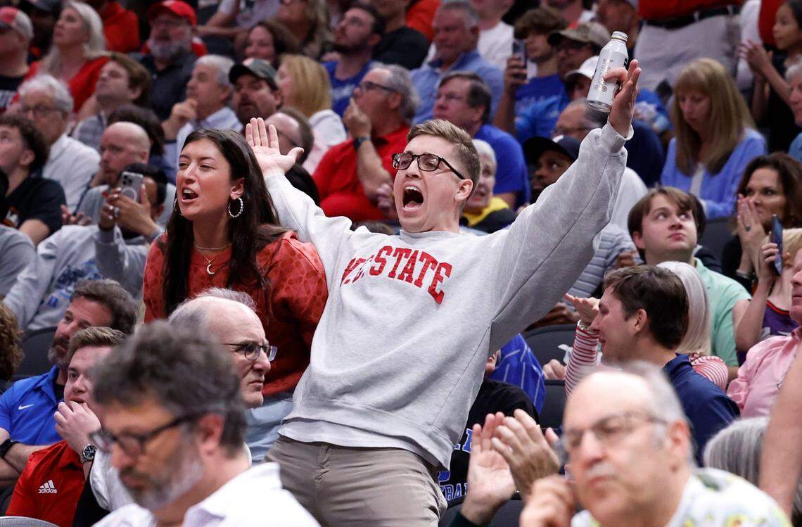 Wolfpack fans cheer on a basket during the second half of N.C. State’s 76-64 victory over Duke in their NCAA Tournament Elite Eight matchup at the American Airlines Center in Dallas, Texas, Sunday, March 31, 2024.