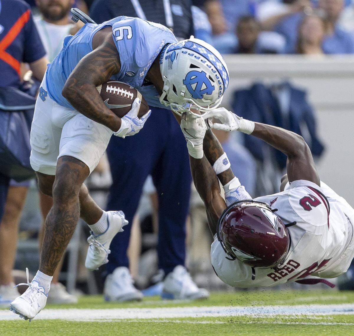 North Carolina Central defensive back Malcolm Reed (2) stops North Carolina wide receiver Nate McCollum (6) with a face mask after a pass reception in the second quarter on Saturday, September 14, 2024 at Kenan Stadium in Chapel Hill, N.C.