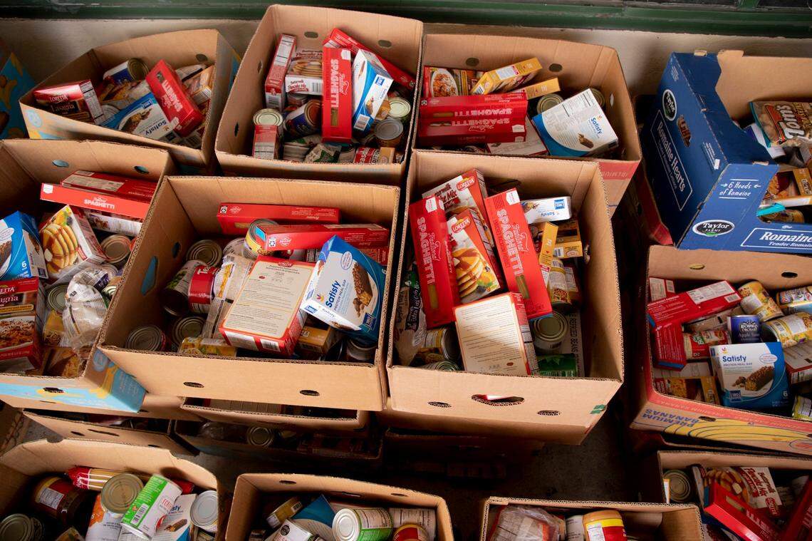 Boxes of food await distribution at the Durham Community Food Pantry, on Wednesday, Dec. 9, 2020, in Durham, N.C.