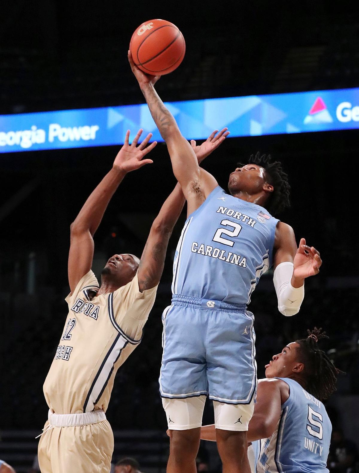 Georgia Tech forward Khalid Moore loses the rebound battle with North Carolina guard Caleb Love during an NCAA college basketball game Wednesday, Dec. 30, 2020, in Atlanta.