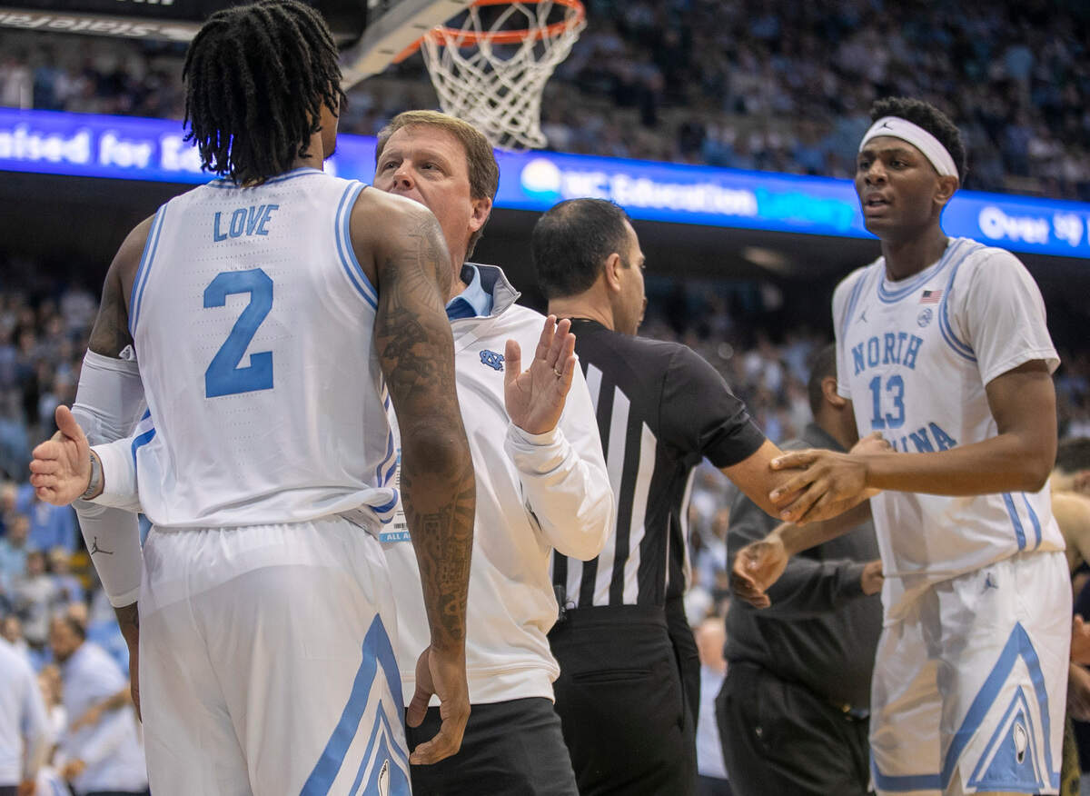 North Carolina associate athletic director Clint Gwaltney restrains Caleb Love after an altercation in the second half against Notre Dame on Saturday, January 7, 2023 at the Smith Center in Chapel Hill, N.C.