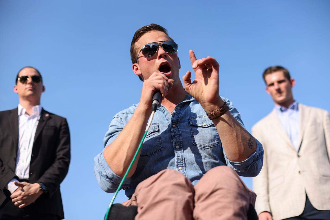 U.S. Rep. Madison Cawthorn addresses a group of demonstrators opposing a mask mandate outside the Johnston County Board of Education meeting on Tuesday, September 14, 2021 in Smithfield, N.C. Congressional candidate Bo Hines is at right.