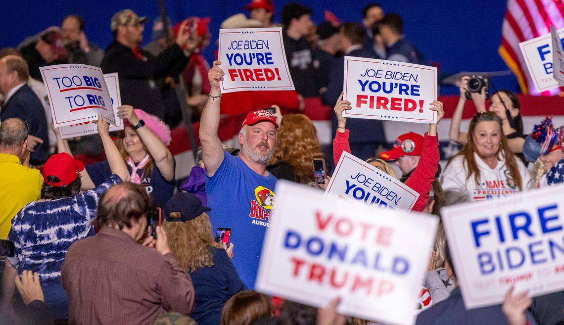 Supporters of former President Donald J. Trump hold up campaign signs during a rally in the Special Events Center at the Greensboro Coliseum Complex on Saturday, March 2, 2024.