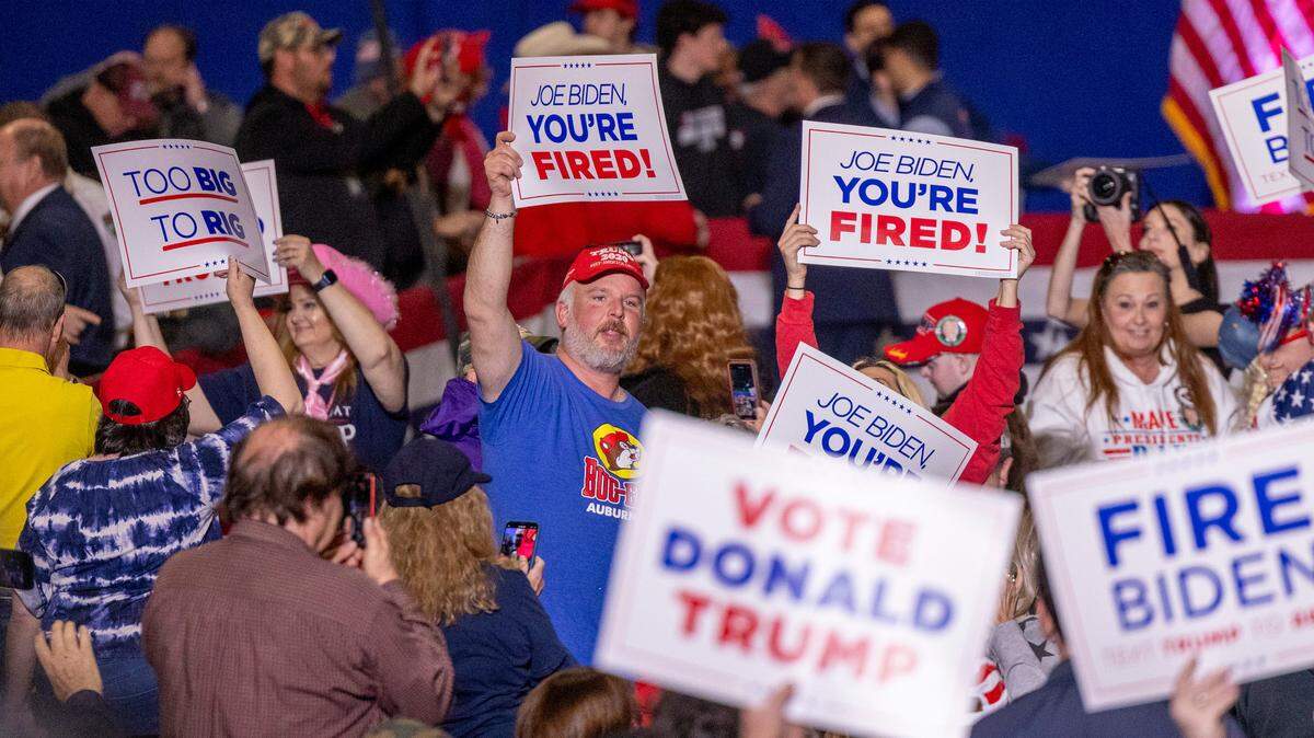 Supporters of former President Donald J. Trump hold up campaign signs during a rally in the Special Events Center at the Greensboro Coliseum Complex on Saturday, March 2, 2024.