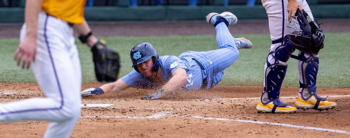 North Carolina first baseman Park Harber (14) slides into home to score on a base hit by Anthony Donofrio in the fourth inning during the NCAA Regional on Sunday, June 2, 2024 at Boshamer Stadium in Chapel Hill, N.C.