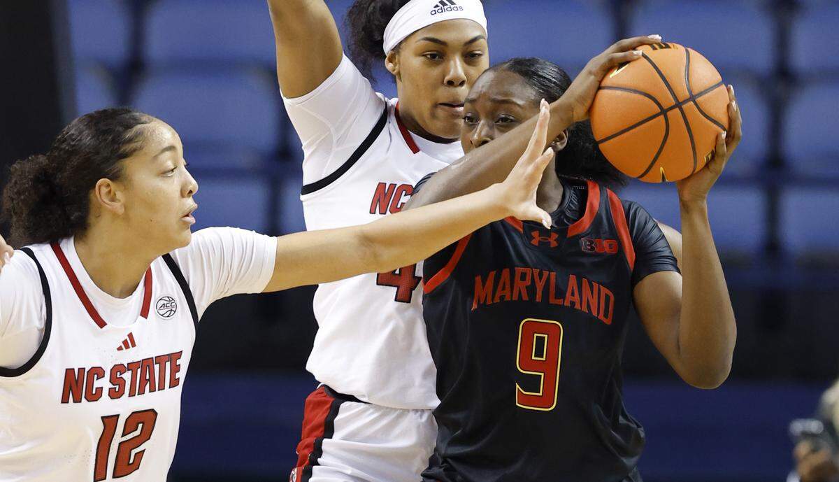 N.C. State's Khamil Pierre (12) and Mallory Collier (42) pressure Maryland's Isimenme Ozzy-Momodu (9) during the first half of N.C. State’s exhibition game against Maryland at the First Horizon Coliseum in Greensboro, N.C., Sunday Oct. 26, 2025.