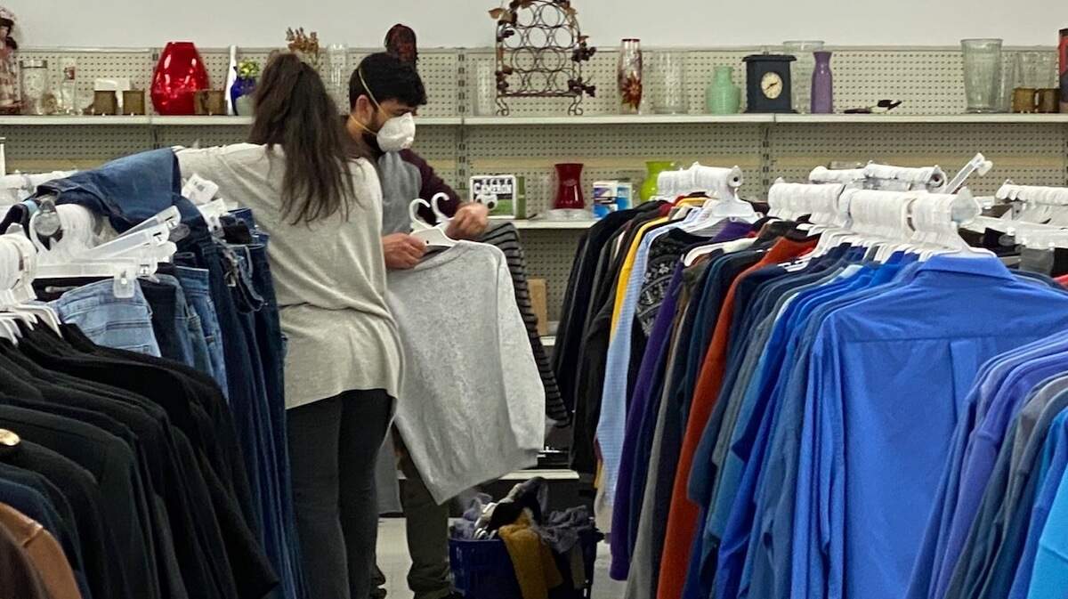 Shoppers wear face masks inside a Goodwill Donation Center and Store in North Raleigh on May 19, 2020.
