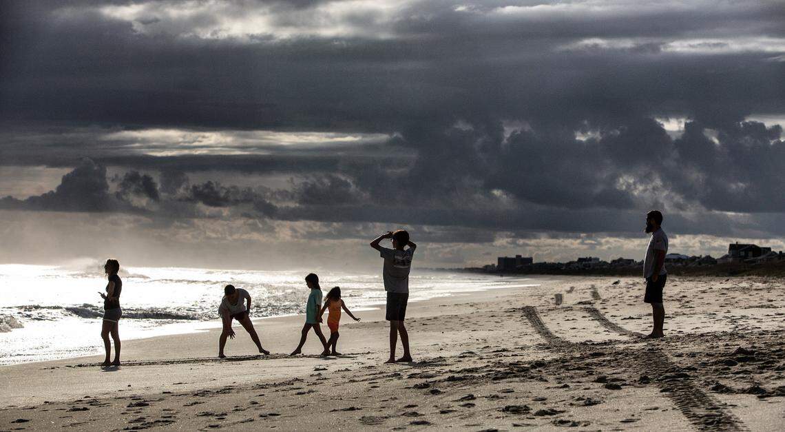 Beachgoers take in the scenery on Atlantic Beach as Hurricane Florence threatens the Carolinas Sept. 12, 2018.