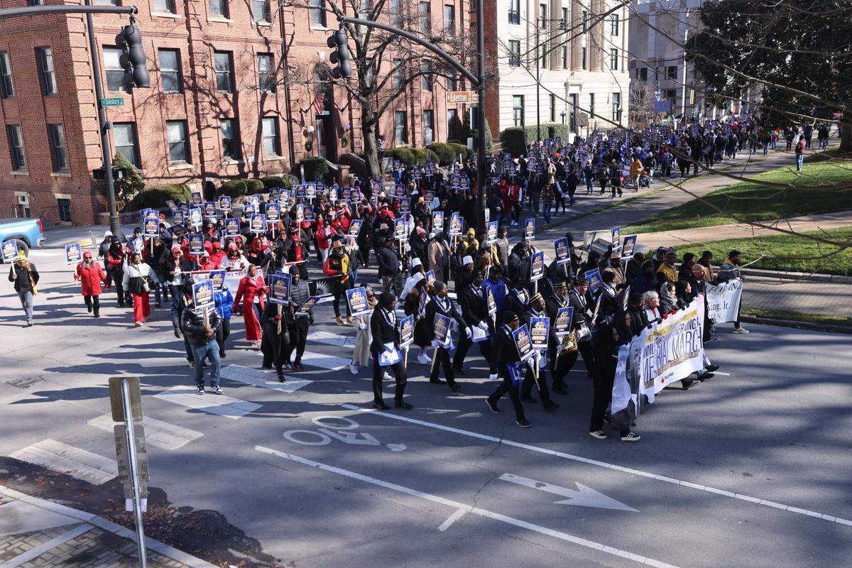 Parade-goers march during the 45th Annual Martin Luther King, Jr. Memorial March in downtown Raleigh on Monday, Jan. 20 ,2025.