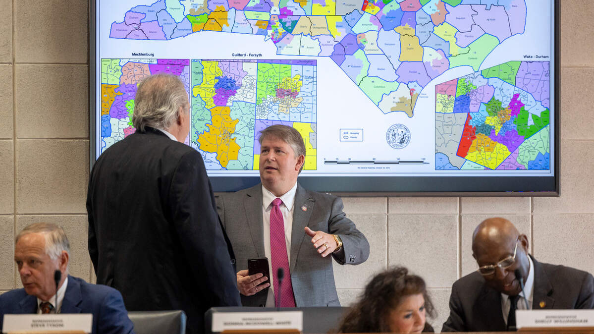 Rep. John Torbett of Gaston County talks with Rep. Grey Mills of Iredell County prior to the House Rules Committee meeting on Oct. 24, 2023 in Raleigh, N.C. The committee approved redistricting maps that are more favorable to Republican candidates.