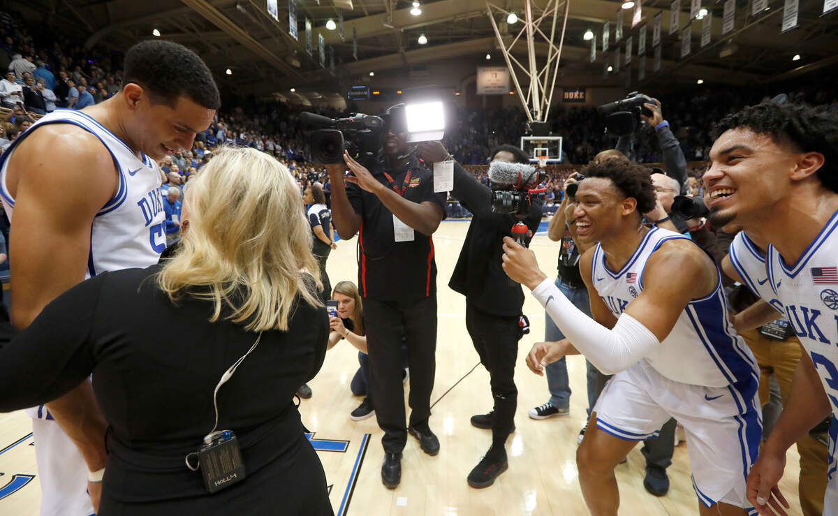 Duke’s Wendell Moore Jr. and Tre Jones enjoy as Justin Robinson is interviewed by Holly Rowe after the Duke Blue Devils’ 89-76 victory over the North Carolina Tar Heels at Cameron Indoor Stadium in Durham, N.C., Saturday, March 7, 2020.
