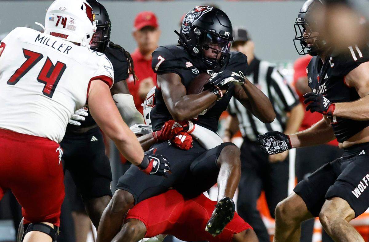 N.C. State cornerback Shyheim Battle (7) intercepts the ball during the first half of N.C. State’s game against Louisville at Carter-Finley Stadium in Raleigh, N.C., Friday, Sept. 29, 2023.