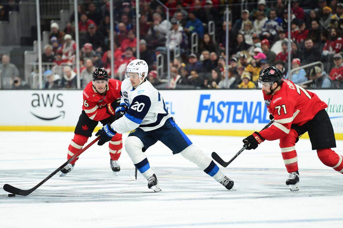 Team Finland forward Sebastian Aho (20) controls the puck while Team Canada forward Anthony Cirelli (71) defends during the second period in a 4 Nations Face-Off ice hockey game at TD Garden.