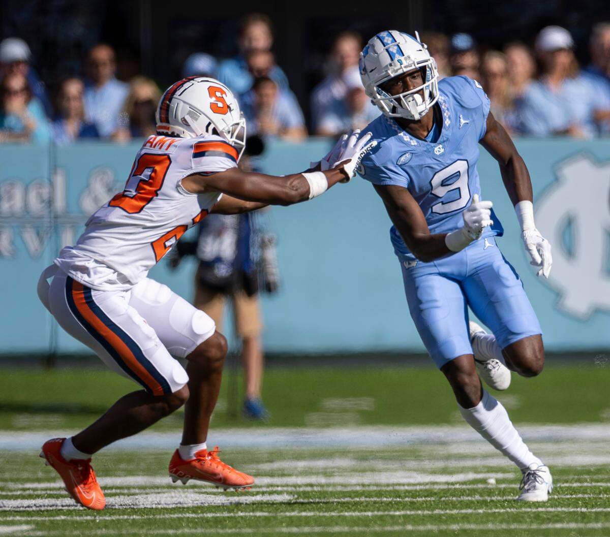 North Carolina wide receiver Devontez Walker (9) runs a route against Syracuse’s Jayden Bellamy (23) in the first quarter on Saturday, October 7, 2023 at Kenan Stadium in Chapel Hill, N.C.