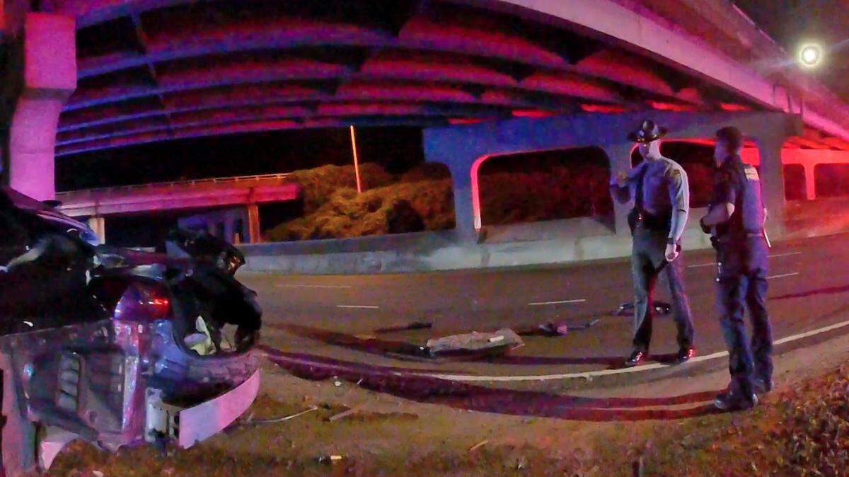 NC State Trooper Garrett Macario talks with a Raleigh police officer at the scene of the wreck that killed Tyrone Mason on Capital Boulevard on Oct. 7, 2024.