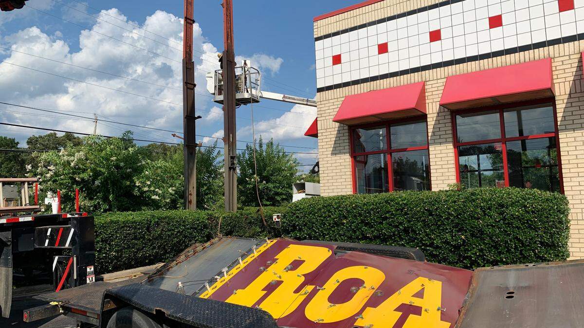 Pieces of the old Arby’s Roast Beef sign lie in a trailer while workers finish dismantling the supports outside the shuttered restaurant on Hillsborough Street in Raleigh. The iconic sign was taken on July 6, 2022.