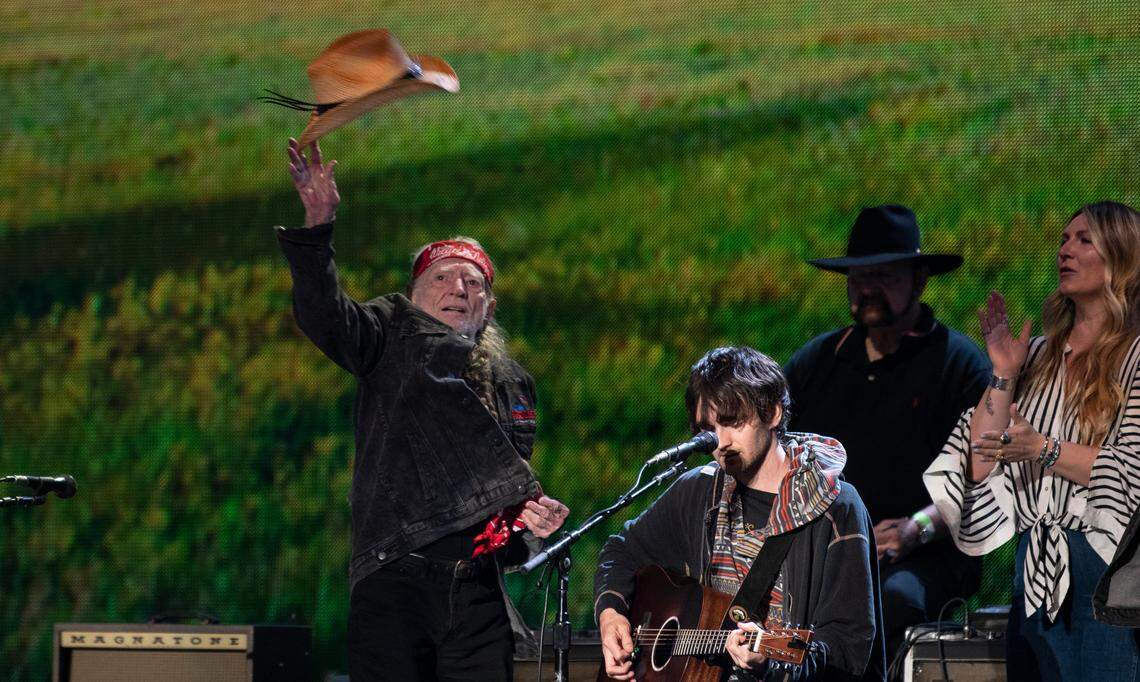 Willie Nelson tosses his hat into the crowd after the finale at Farm Aid at Raleigh, N.C.’s Coastal Credit Union Music Park at Walnut Creek, Saturday, Sept. 24, 2022.