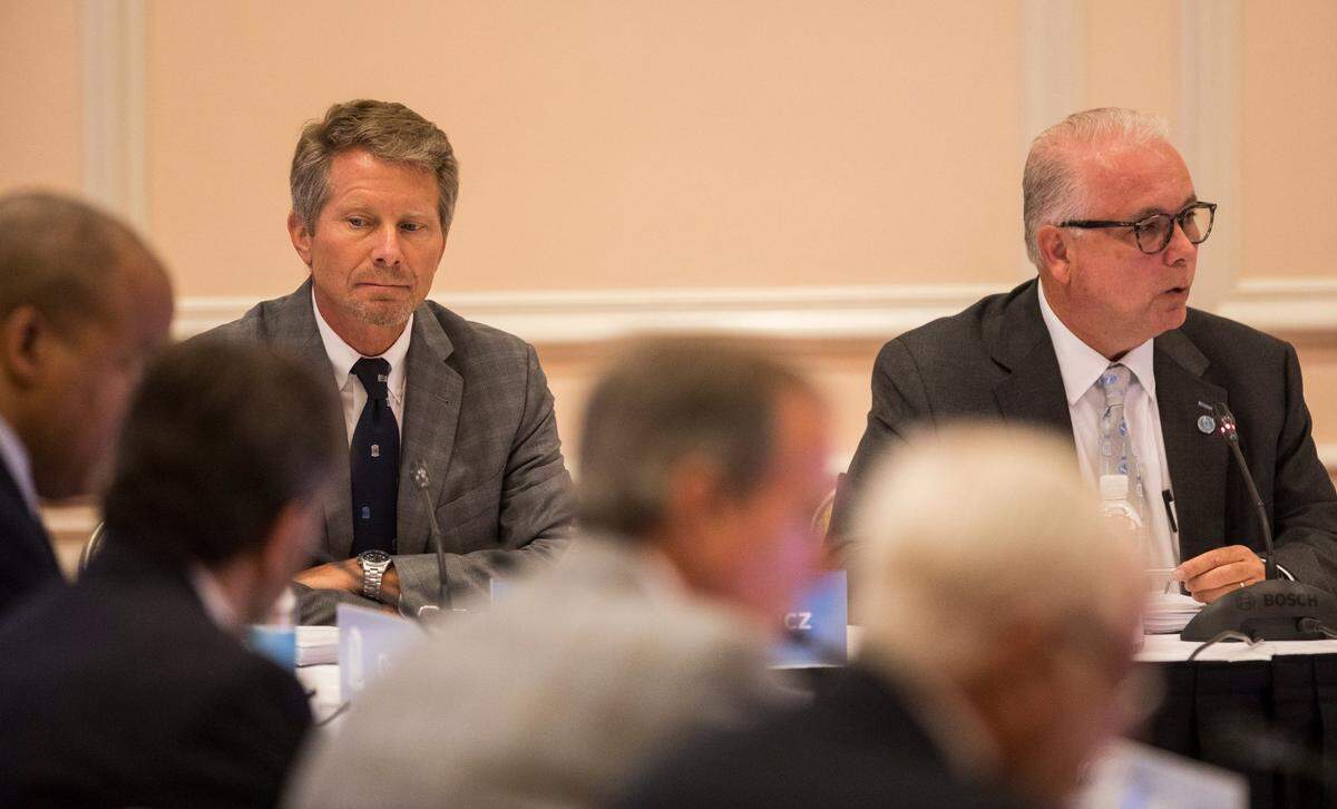 UNC-Chapel Hill Chancellor Kevin Guskiewicz, left, listens as Board of Trustees Chairman Dave Boliek, right, speaks to the board at a July 2021 meeting. Guskiewicz is leaving UNC to become president of Michigan State University.