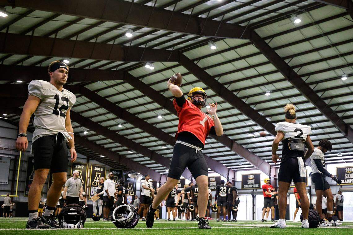 Appalachian State quarterback Chase Brice (7) warms up with teammates during practice in Boone, N.C., Tuesday, Aug. 30, 2022. The Appalachian State Mountaineers football team is preparing to host UNC this weekend.