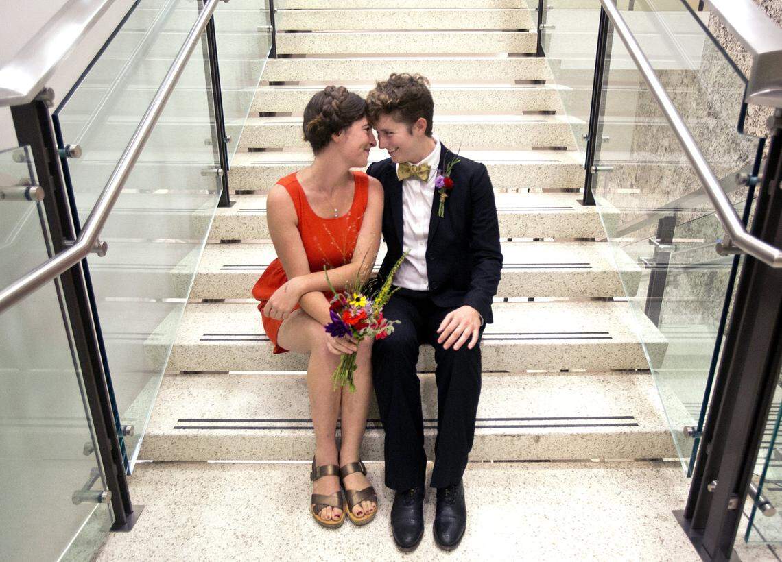 Emily-Kate Hannapel, center, celebrates with her new wife Laura Stephenson, right, both 26, of Durham, after getting married at the Wake County Justice Center in Raleigh, N.C. after 8pm on Friday, October 10, 2014. They were one of the 51 licenses issued after a ruling by U.S. District Judge Max Cogburn which paved the way for the first gay marriages to take place.