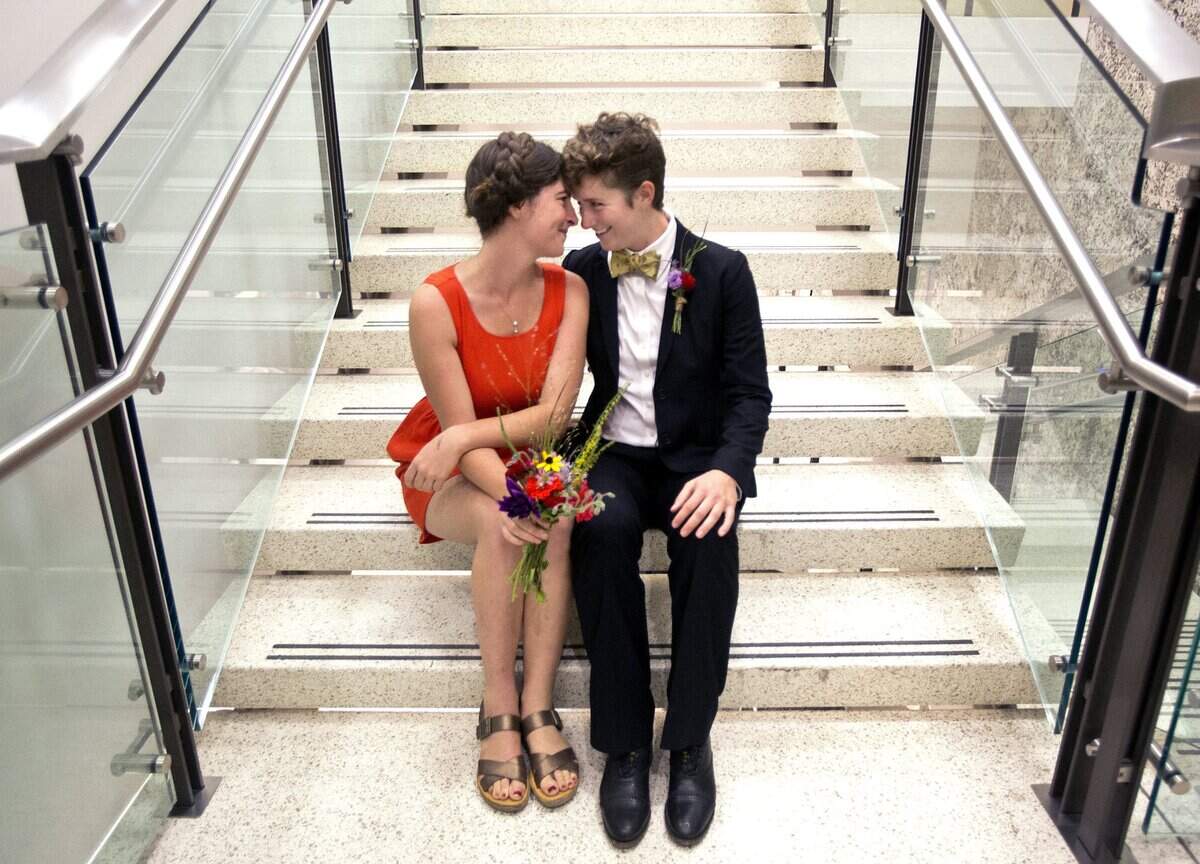 Emily-Kate Hannapel, center, celebrates with her new wife Laura Stephenson, right, both 26, of Durham, after getting married at the Wake County Justice Center in Raleigh, N.C. after 8pm on Friday, October 10, 2014. They were one of the 51 licenses issued after a ruling by U.S. District Judge Max Cogburn which paved the way for the first gay marriages to take place.