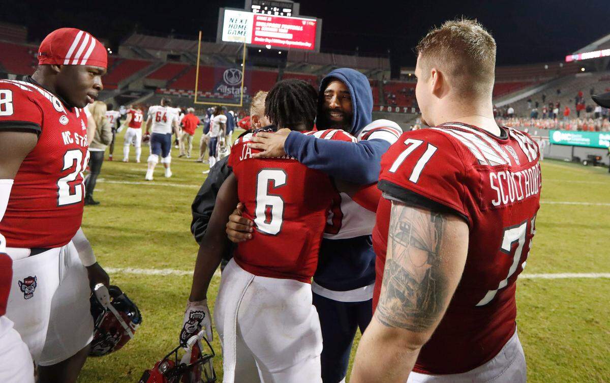 N.C. State safety Jakeen Harris (6) and Liberty safety Tim Kidd-Glass (0) greet each other after N.C. State’s 15-14 victory over Liberty at Carter-Finley Stadium in Raleigh, N.C., Saturday, Nov. 21, 2020.
