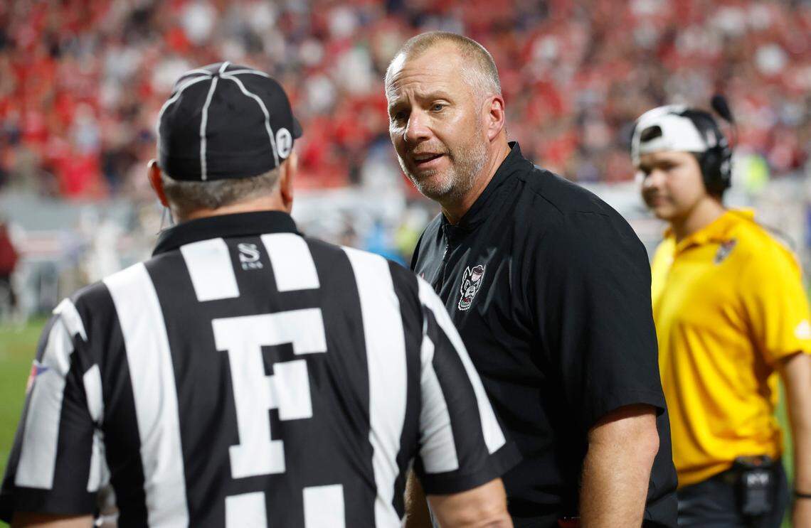 N.C. State head coach Dave Doeren talks with the official after linebacker Drake Thomas (32) was called for pass interference late in the second half of Boston College’s 21-20 victory over N.C. State at Carter-Finley Stadium in Raleigh, N.C., Saturday, Nov. 12, 2022.