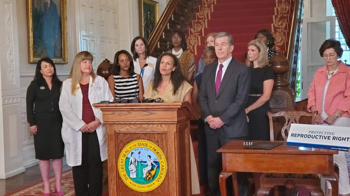 Planned Parenthood Action Fund President Alexis McGill Johnson speaks at the North Carolina Executive Mansion about abortion rights and an executive order by Democratic Gov. Roy Cooper, right, and several women lawmakers and legislative candidates on Wednesday, July 6, 2022 in Raleigh.