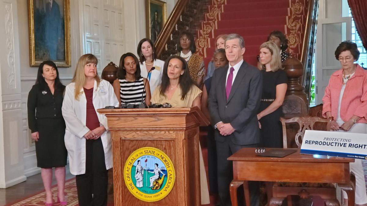 Planned Parenthood Action Fund President Alexis McGill Johnson speaks at the North Carolina Executive Mansion about abortion rights and an executive order by Democratic Gov. Roy Cooper, right, and several women lawmakers and legislative candidates on Wednesday, July 6, 2022 in Raleigh.