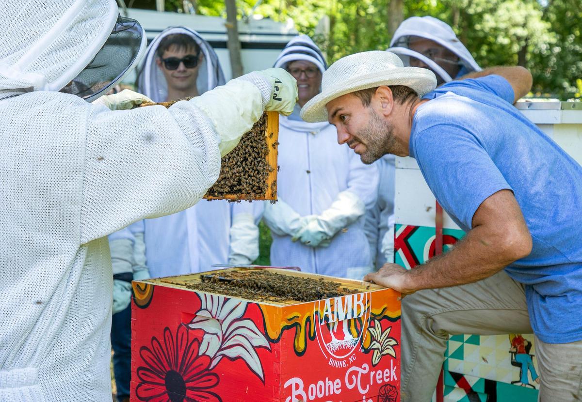 Ben Dictus, Lead North Carolina Beekeeper for Bee Downtown, leads a hive tour with a group of employees of various companies at American Tobacco on Friday, Jun. 14, 2019, in Durham, NC.