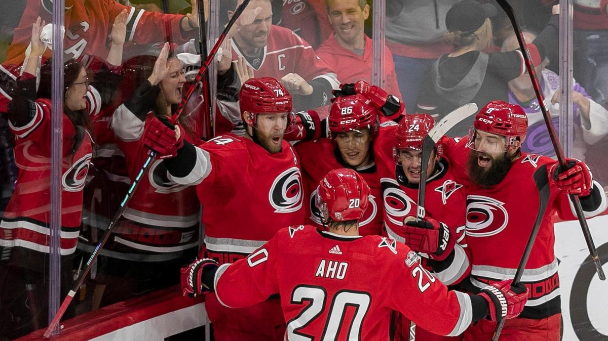 Carolina Hurricanes defenseman Jaccob Slavin (74) is surrounded by teammates after scoring to tie the New York Islanders 3-3 in the third period, forcing overtime during Game 2 of their Stanley Cup series on Wednesday, April 18, 2023 at PNC Arena in Raleigh, N.C.
