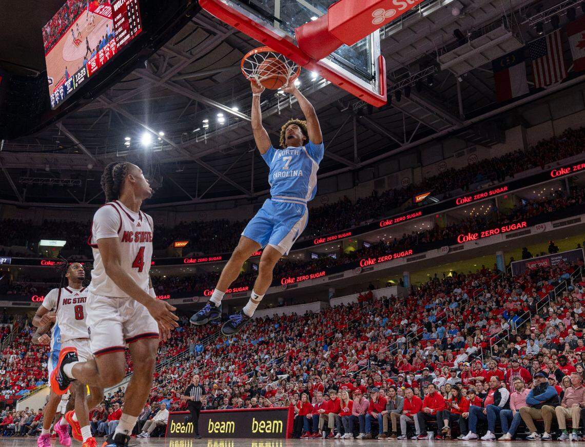 North Carolina guard Seth Trimble (7) breaks to the basket for a dunk over N.C. State’s Breon Pass (4) in the second half on Saturday, January 11, 2025 at Lenovo Center in Raleigh, N.C.