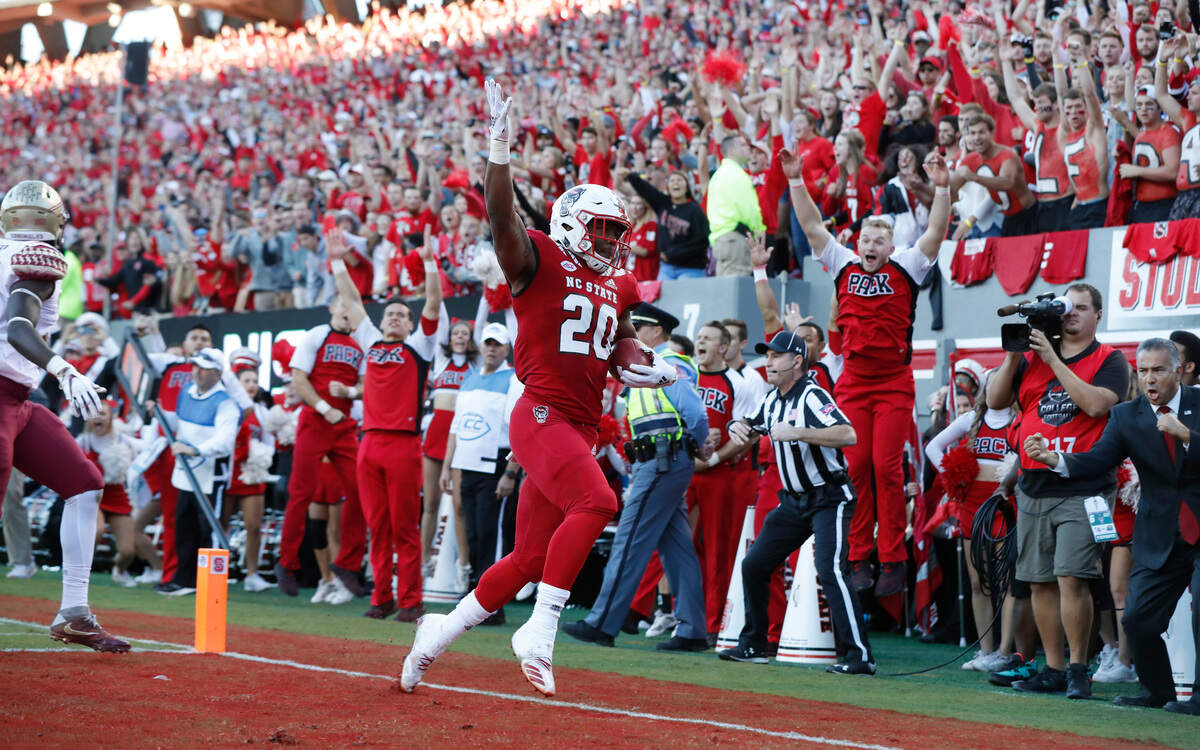 N.C. State running back Ricky Person (20) celebrates scoring on a four-yard touchdown run during the first half of N.C. State’s game against Florida State at Carter-Finley Stadium in Raleigh, N.C., Saturday, Nov. 3, 2018.
