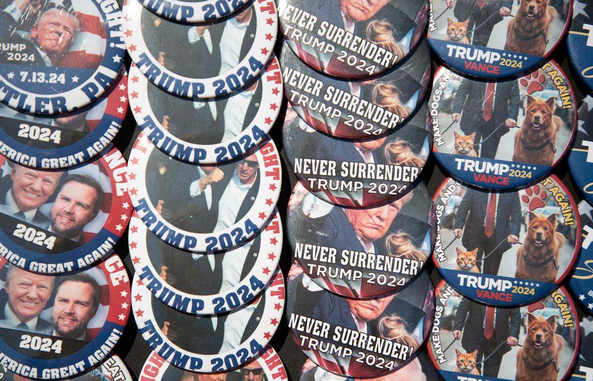 Buttons feature former President Donald Trump and Republican vice presidential candidate J.D. Vance outside of Greensboro Coliseum prior to a rally on Tuesday, Oct. 22, 2024, in Greensboro, N.C.