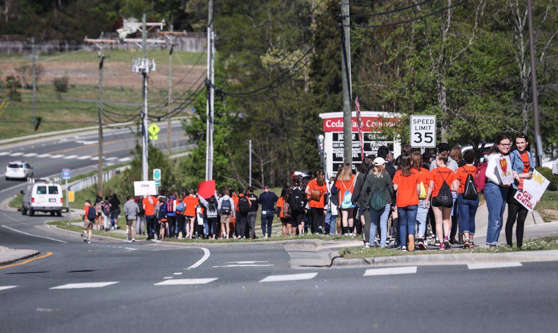 East Chapel Hill High School students walk down Weaver Dairy Road before turning into a neighborhood and making their way towards Franklin St. on April 20, 2018. They marched 4.6 miles, along with students from other schools in the district, to rally against gun violence in Peace and Justice Plaza on the 19th anniversary of the Columbine school shooting. 