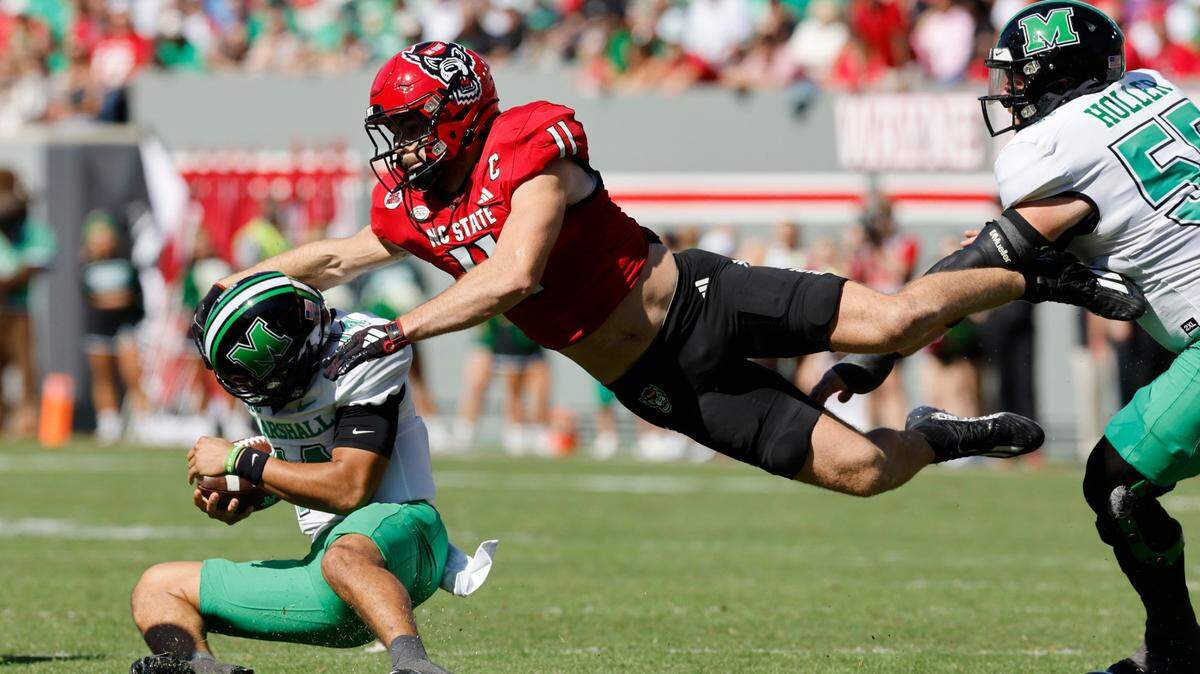 N.C. State linebacker Payton Wilson (11) tackles Marshall quarterback Cam Fancher (14) during the first half of N.C. State’s game against Marshall at Carter-Finley Stadium in Raleigh, N.C., Saturday, Oct. 7, 2023.