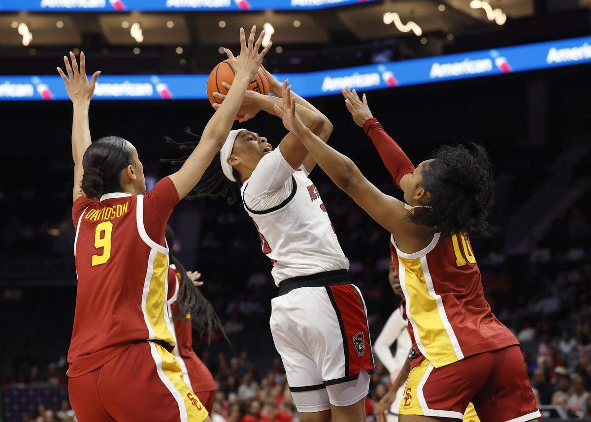 N.C. State’s Zoe Brooks looks to shoot over Southern California’s Jazzy Davidson and Malia Samuels during the first half of the Wolfpack’s game on Sunday, Nov. 9, 2025, at Spectrum Center in Charlotte, North Carolina.