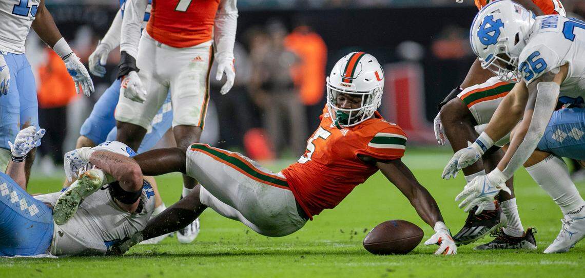 North Carolina’s John Copenhaver (81) forces Miami’s Key’Shawn Smith (5) to fumble the ball on a kick off return in the fourth quarter on Saturday, October 8, 2022 at Hard Rock Stadium in Miami Gardens, Florida.