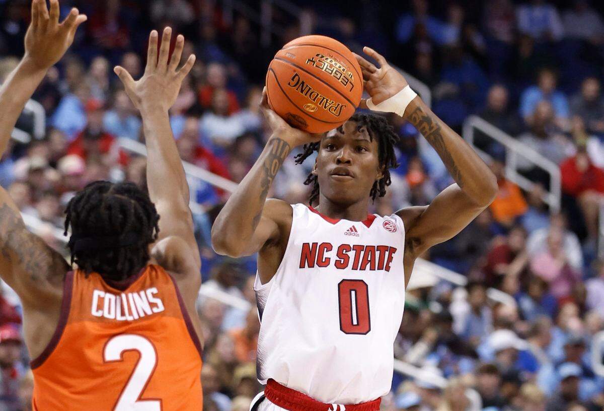 N.C. State’s Terquavion Smith (0) shoots as Virginia Tech’s MJ Collins (2) defends during the first half of N.C. State’s game against Virginia Tech in the second round of the ACC Men’s Basketball Tournament in Greensboro, N.C., Wednesday, March 8, 2023.