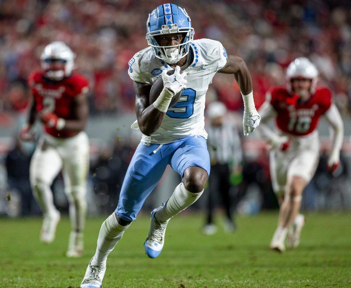 North Carolina’s Devontez Walker (9) scores on a 21-yard pass completion from quarterback Drake Maye in the third quarter against N.C. State on Saturday, November 25, 2023 at Carter-Finley Stadium in Raleigh, N.C.