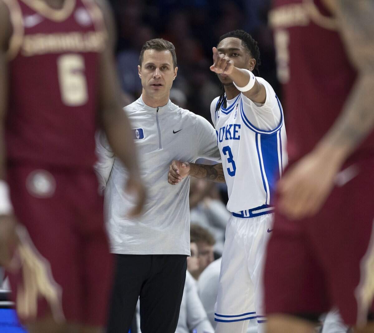 Duke forward Isaiah Evans (3) confers with coach Jon Scheyer, during the first half against Florida State on Thursday, March 12, 2026, during the quarterfinals of the ACC Tournament at Spectrum Center in Charlotte, N.C